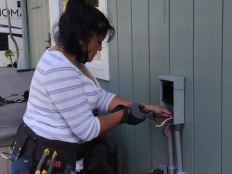 Licensed electrician wiring an exterior subpanel in Midway North